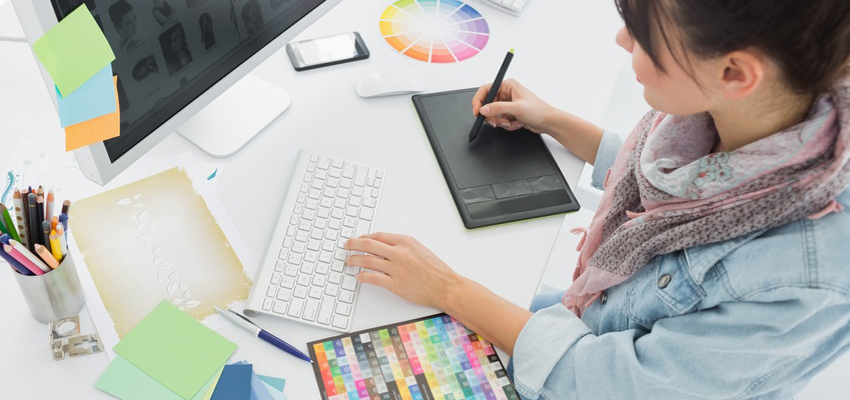 Artist drawing something on graphic tablet at office